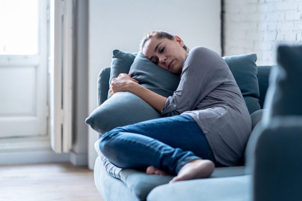 woman_lying_on_her_couch_at_home_not_feeling_well